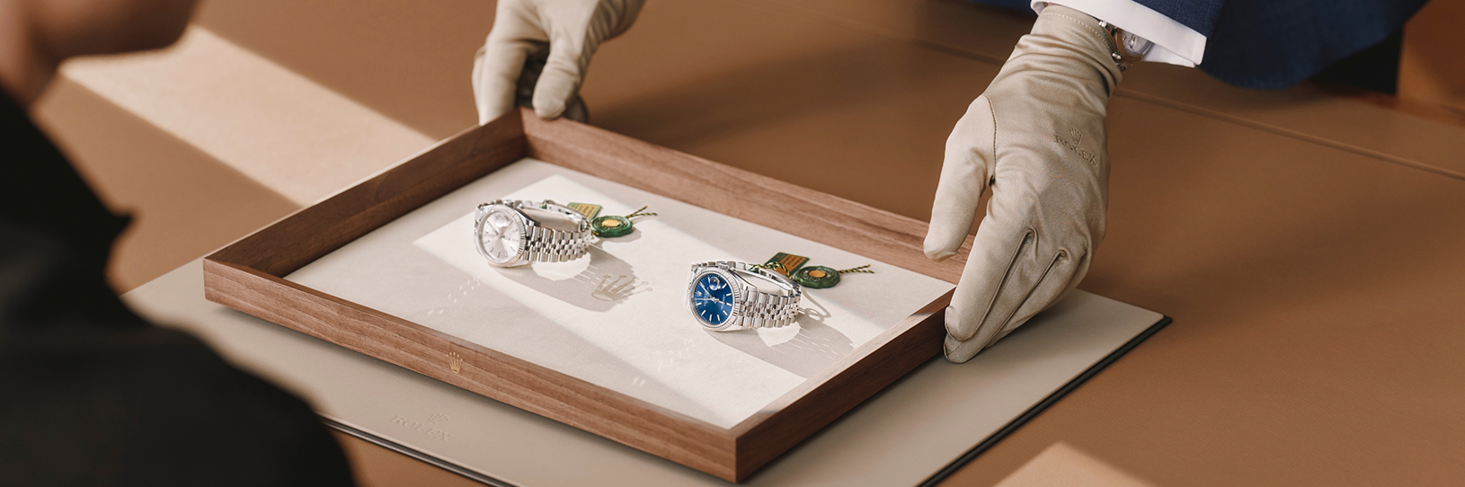 Rolex House staff presenting watches