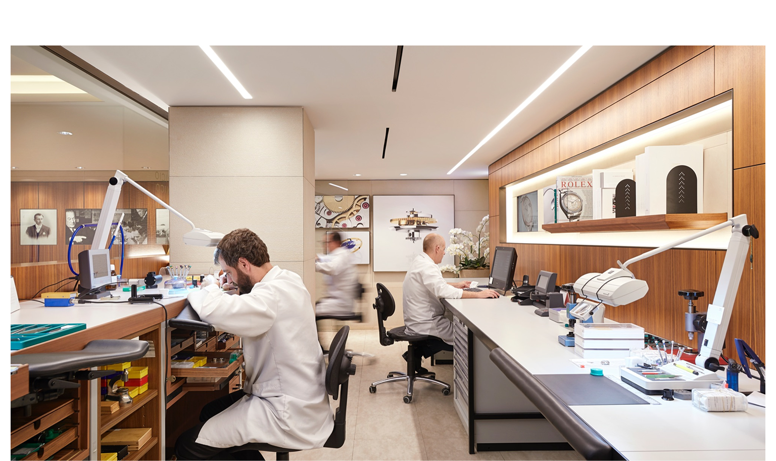 Rolex watchmakers servicing watches at benches in a workshop