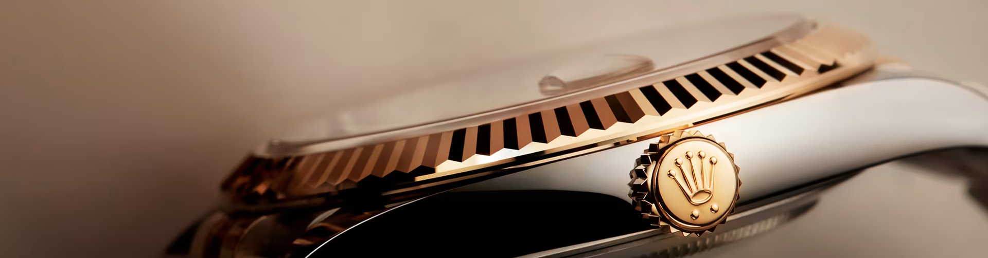 Close-up of a Rolex crown and fluted bezel