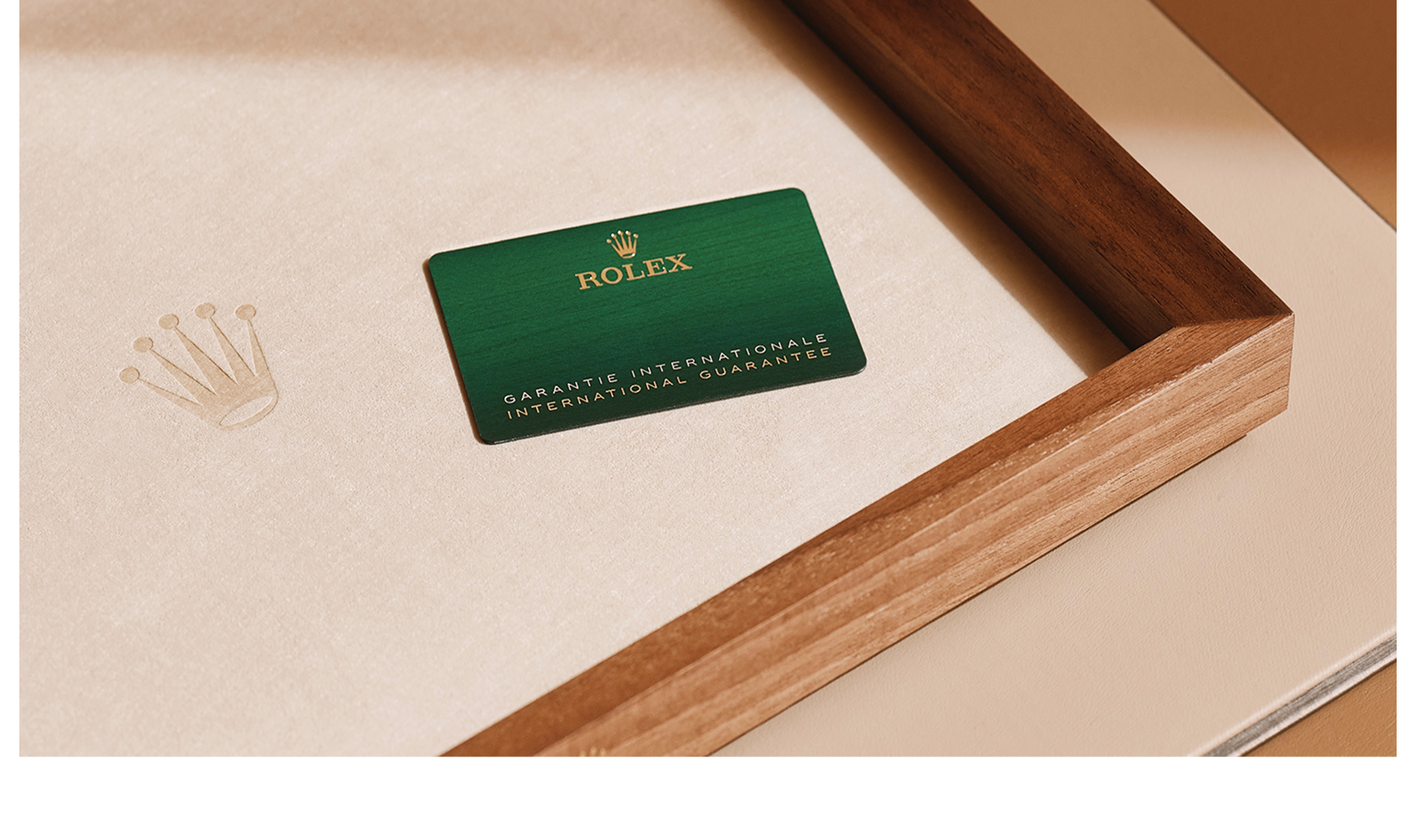 A Rolex International Guarantee card resting in a wooden tray